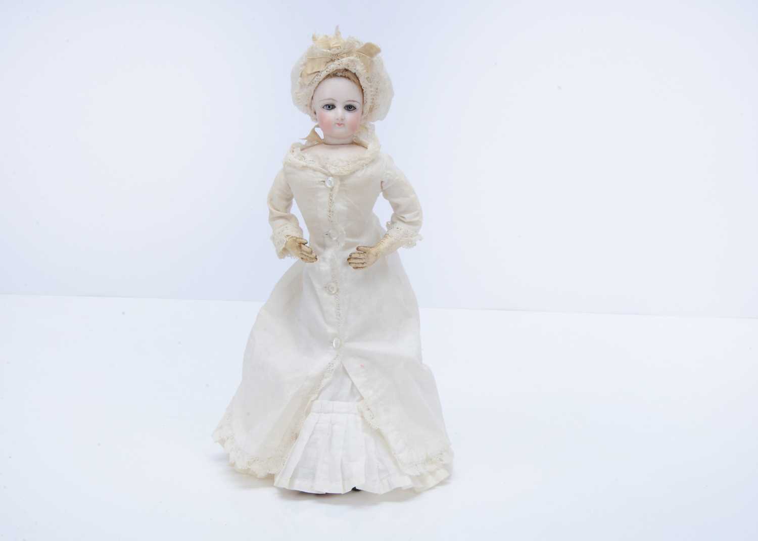 Lot 1435 - A small French swivel head fashion doll