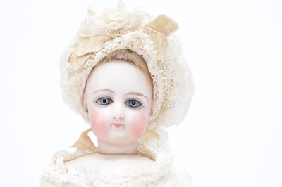 Lot 1435 - A small French swivel head fashion doll
