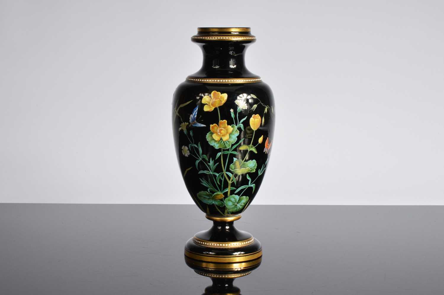 Lot 17 - An early 20th century Moser style black glass vase