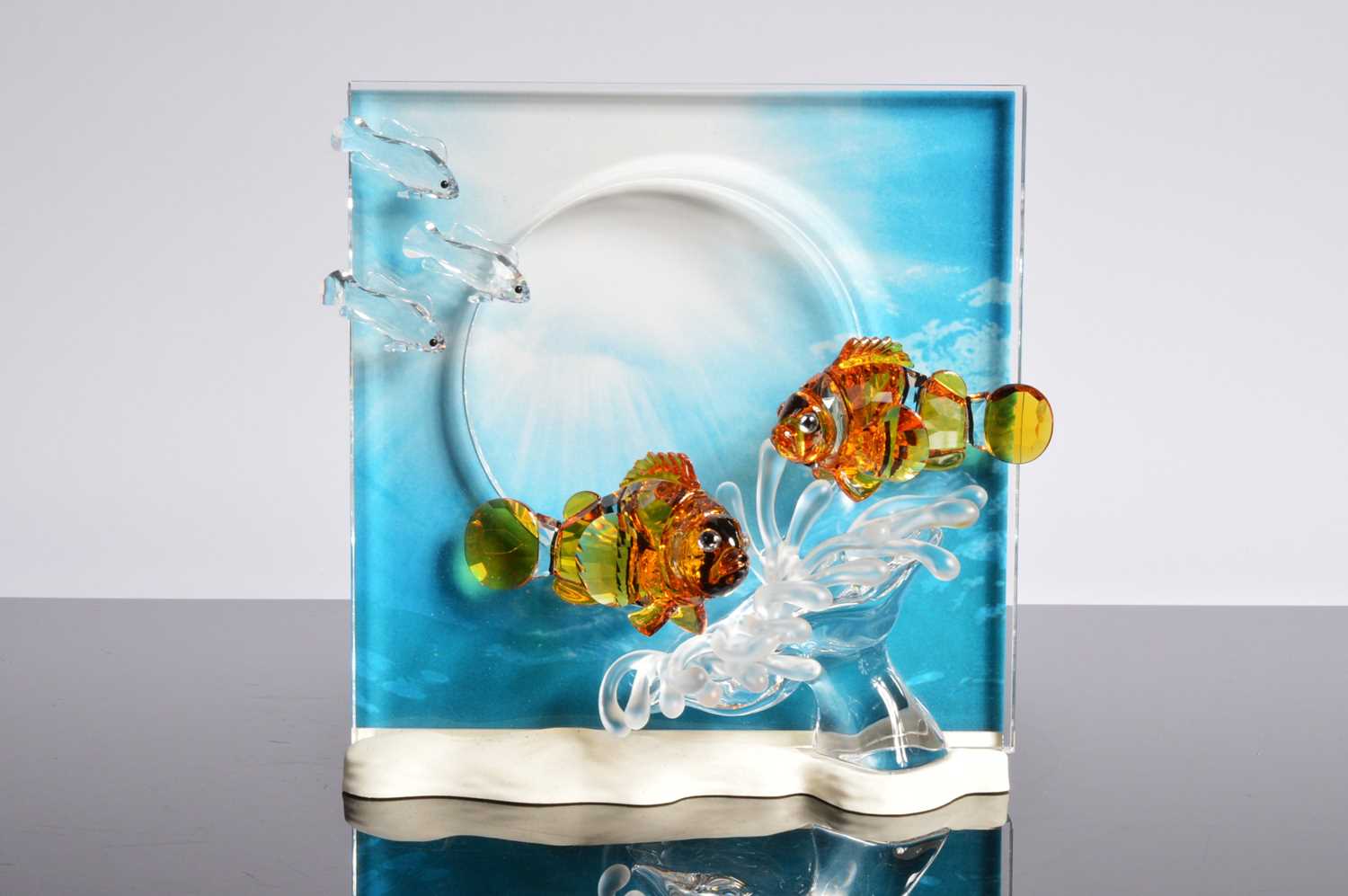 Lot 57 - A Swarovski Orange colored Clownfish over a frosted sea anemone