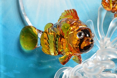 Lot 57 - A Swarovski Orange colored Clownfish over a frosted sea anemone