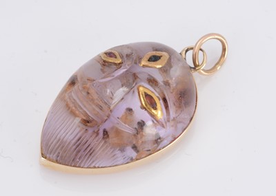 Lot 12 - An Indian amethyst gold and gem set deity pendant