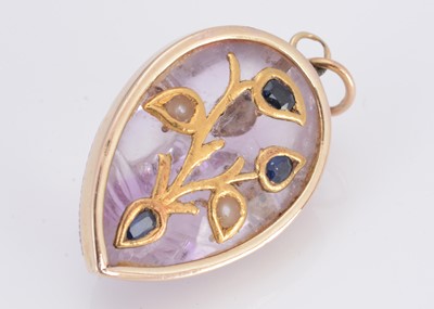 Lot 12 - An Indian amethyst gold and gem set deity pendant