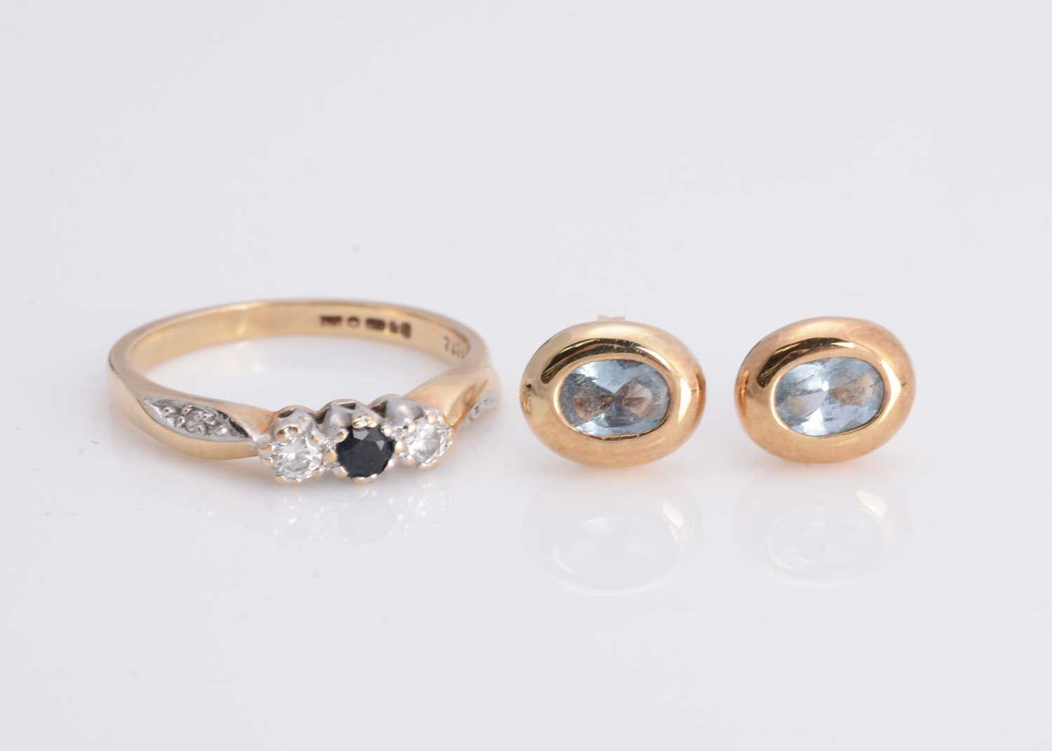 Lot 22 - A 9ct gold three stone diamond and sapphire dress ring