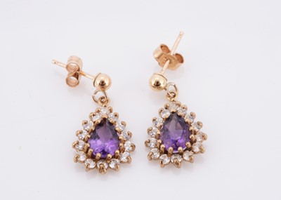 Lot 60 - A pair of amethyst and cubic zirconia drop oval earrings
