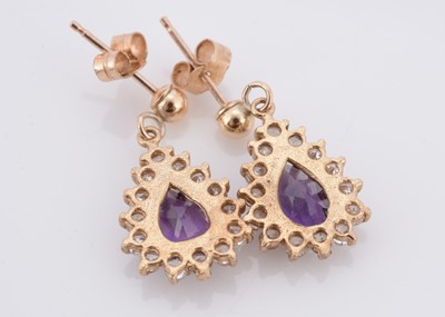 Lot 60 - A pair of amethyst and cubic zirconia drop oval earrings