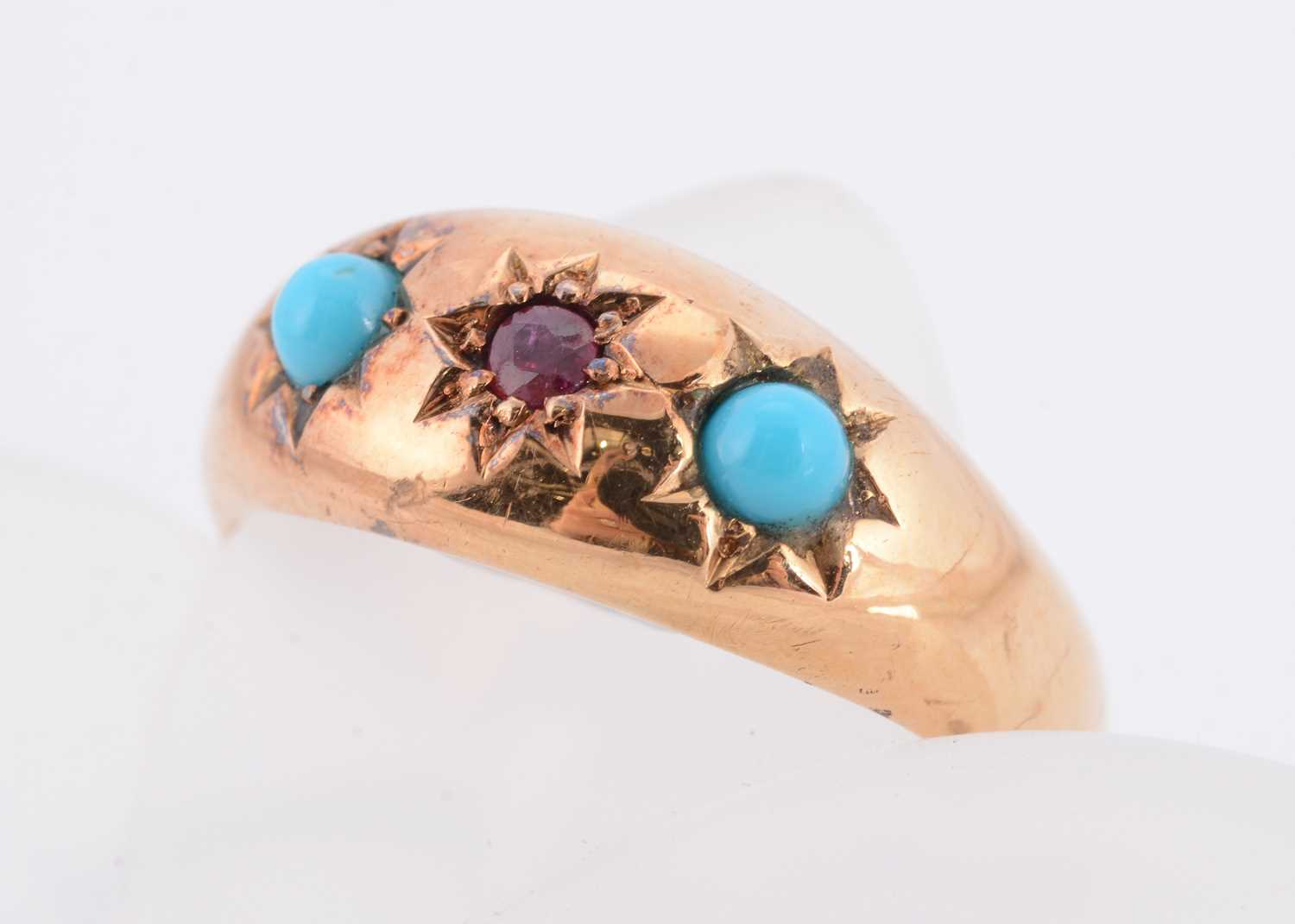 Lot 66 - A three stone Edwardian 18ct gold ruby and turquoise dress ring