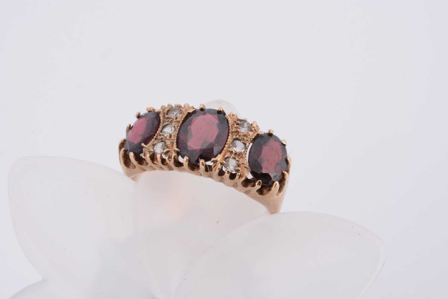 Lot 71 - A 9ct gold garnet and white topaz dress ring