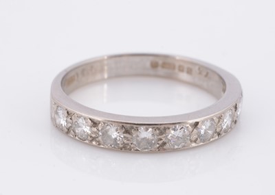 Lot 77 - An 18ct gold nine stone diamond half hoop eternity ring