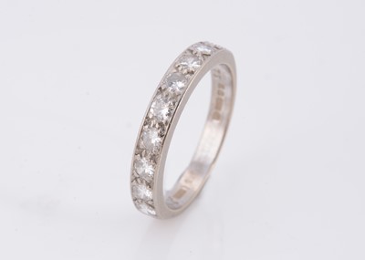 Lot 77 - An 18ct gold nine stone diamond half hoop eternity ring