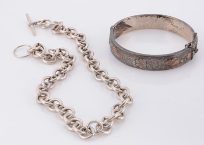 Lot 81 - A silver and yellow metal hinged bangle