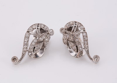 Lot 104 - A pair of art deco diamond set clip scroll earrings