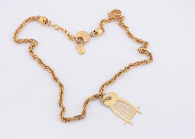 Lot 111 - An Yves Saint Laurent gilt metal chain with associated harp pendant