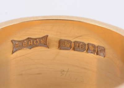 Lot 118 - An 18ct gold wide engraved wedding band