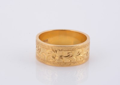 Lot 119 - A 22ct gold wide engraved wedding band
