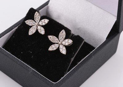 Lot 139 - A pair of white 18ct gold diamond set stud earrings of floral design