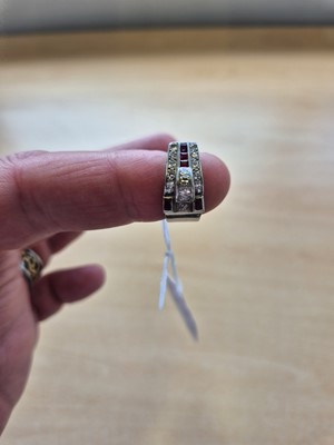 Lot 141 - An art deco ruby and diamond stylised buckle ring