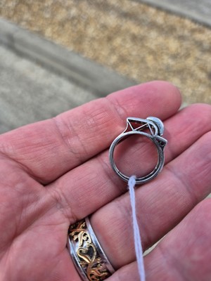 Lot 141 - An art deco ruby and diamond stylised buckle ring