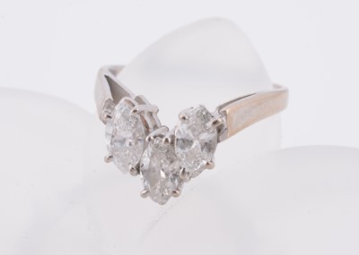Lot 142 - A three stone 18ct white gold diamond set wishbone dress ring
