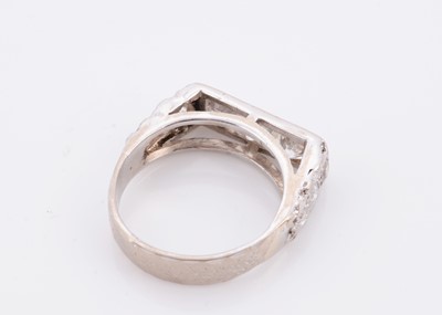 Lot 144 - A three stone diamond set 18ct white gold lady's dress ring