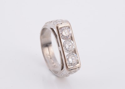 Lot 144 - A three stone diamond set 18ct white gold lady's dress ring