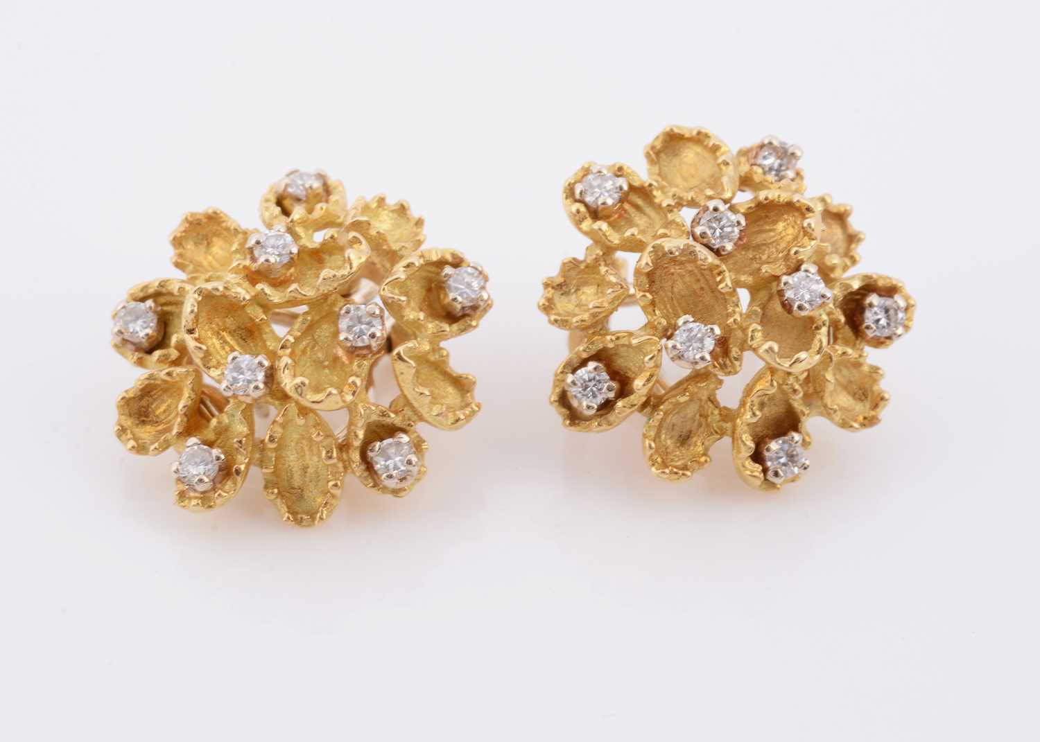 Lot 148 - A pair of diamond and 18ct (tested) clip earrings
