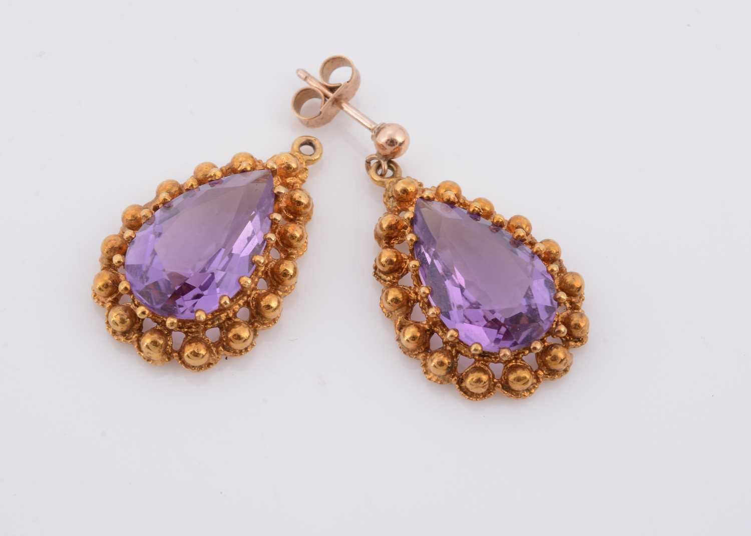 Lot 149 - A pair of pear shaped amethyst drop earrings