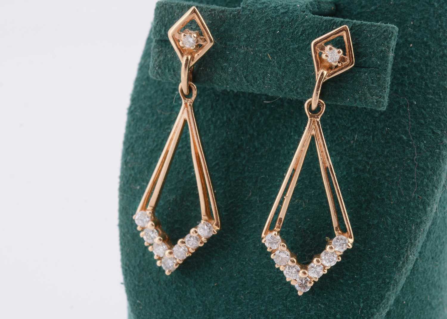 Lot 150 - A pair of yellow metal and diamond set chevron shaped earrings
