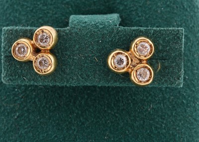 Lot 152 - A pair of 18ct gold diamond set triple ear studs