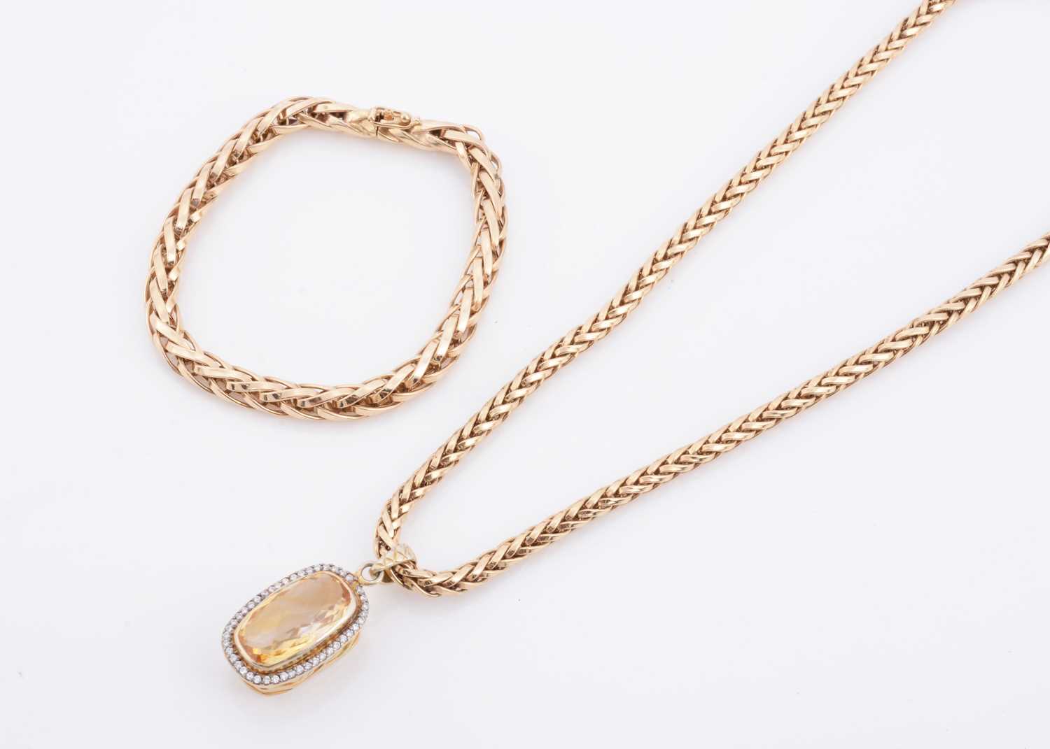 Lot 155 - A Citrine and diamond cluster pendant on a chevron link necklace