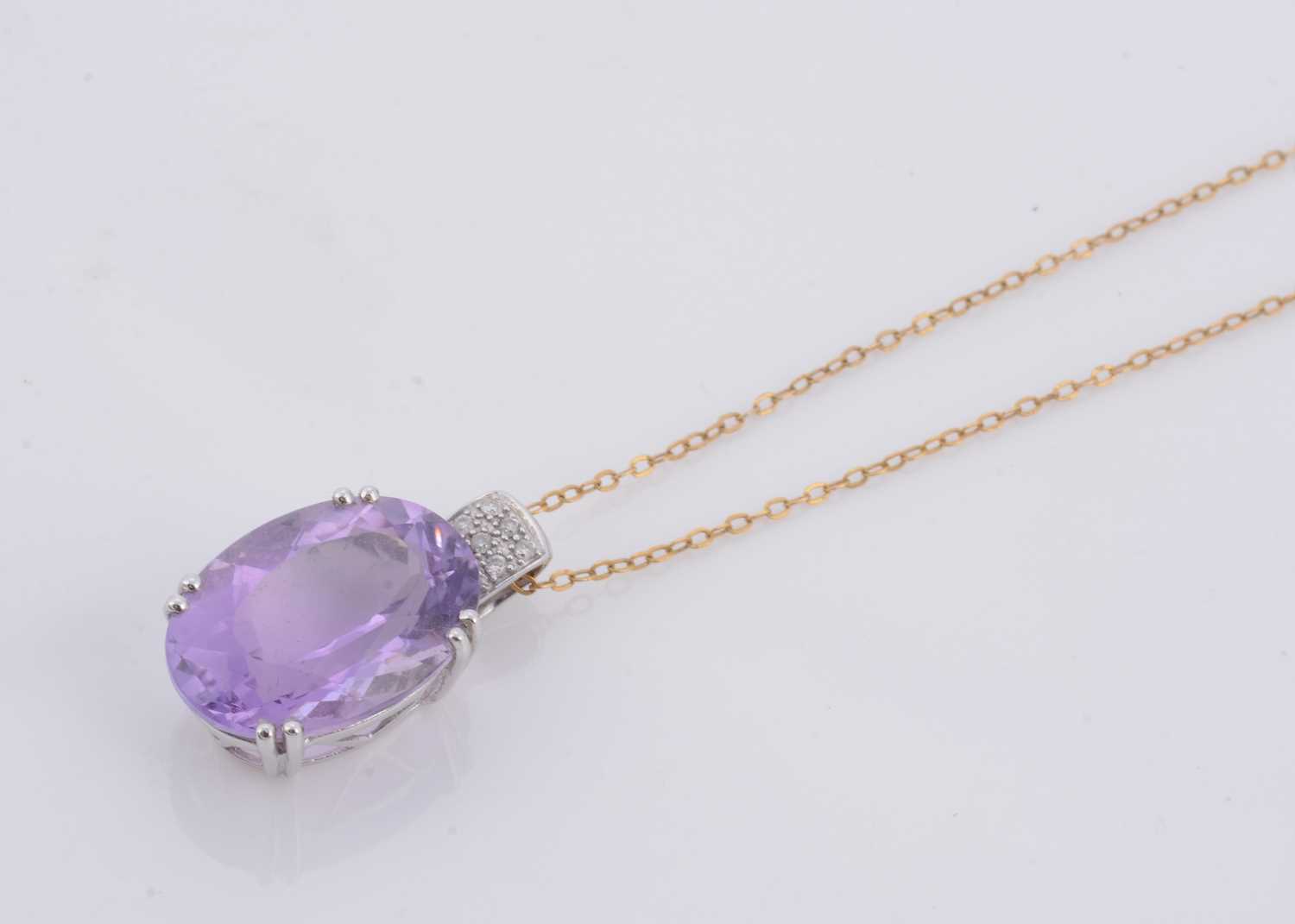 Lot 156 - An amethyst and diamond pendant and chain