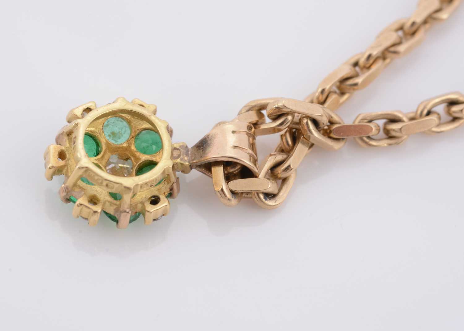 Lot 157 - An 18ct gold emerald and diamond cluster pendant