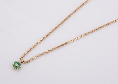 Lot 157 - An 18ct gold emerald and diamond cluster pendant