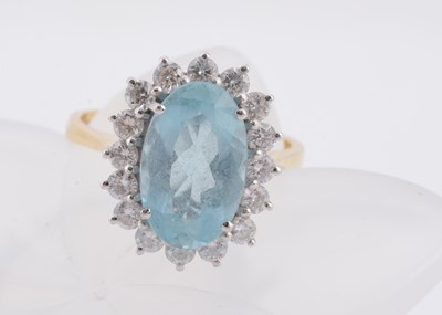 Lot 171 - An 18ct gold aquamarine and diamond set cluster ring