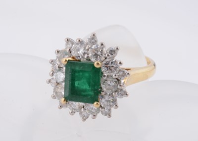 Lot 172 - An 18ct gold two colour emerald and diamond cluster ring