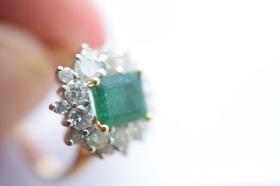 Lot 172 - An 18ct gold two colour emerald and diamond cluster ring