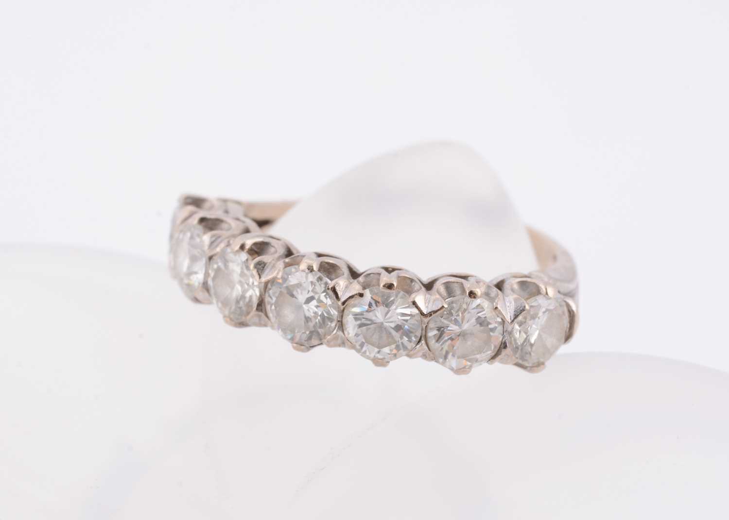 Lot 176 - An 18ct gold diamond half hoop eternity ring