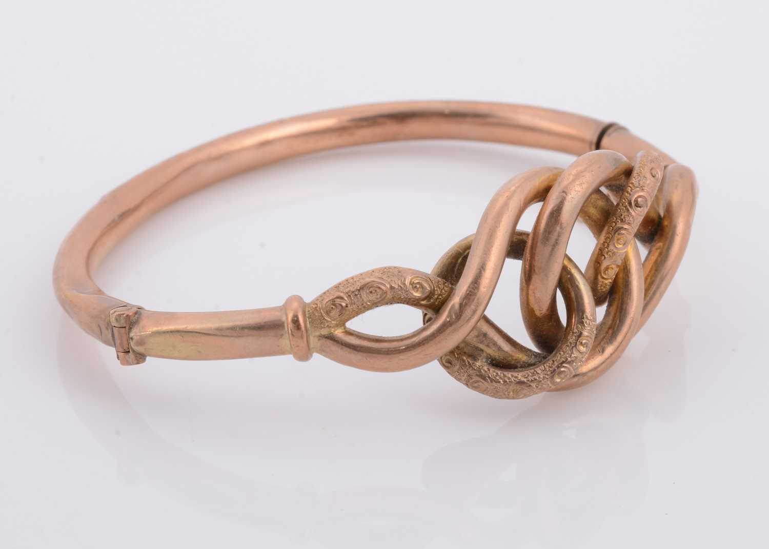 Lot 185 - A Victorian yellow metal hollow knot bangle