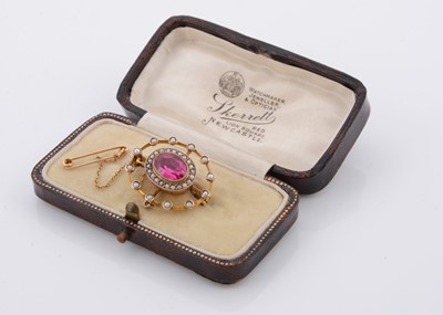 Lot 214 - An Edwardian seed pearl and synthetic ruby oval brooch, of pierced design