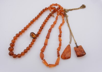 Lot 242 - A string of graduated spherical amber beads