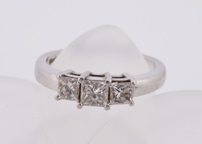 Lot 248 - A platinum three stone princess cut diamond dress ring