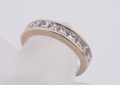 Lot 249 - A white 18ct gold channel set half hoop eternity ring