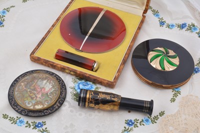 Lot 285 - A French Art Deco chrome and red enamelled compact and scent