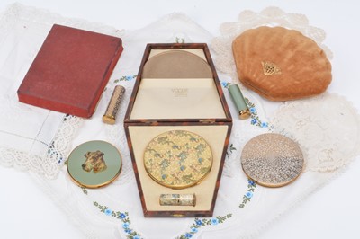 Lot 340 - A Vogue Vanities figures with dragons and birds decorated circular compact with matching lipstick