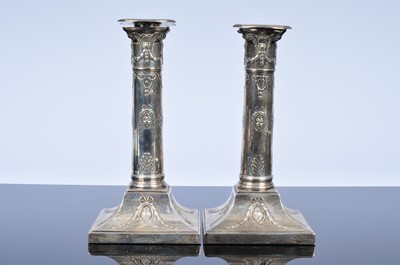 Lot 384 - An Edwardian pair of silver filled candlesticks from Mappin & Webb