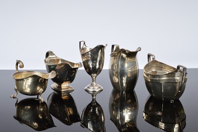 Lot 385 - Four Victorian and later silver jugs and a sugar basin