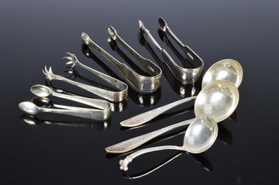 Lot 397 - Four pairs of silver sugar tongs and three serving spoons