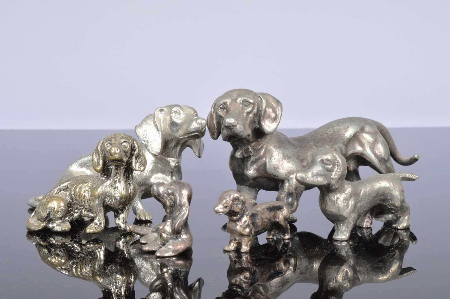 Lot 406 - Two miniature silver models of dogs and four