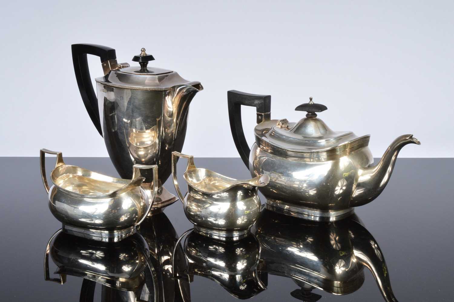 Lot 438 - A George V and later associated four piece silver tea set