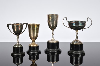 Lot 466 - A George V silver trophy goblet and three silver plated examples